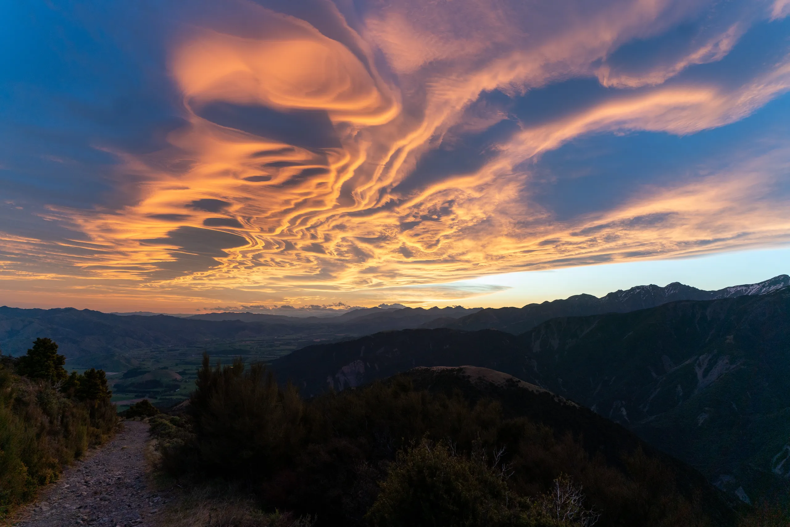 Complex cloud patterns illuminated by sunset